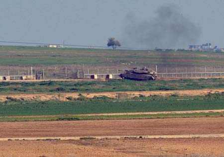 An Israeli tank takes position in the northern Gaza Strip Jan. 5, 2009. Israel continued on Monday its military attacks on the Palestinians in the Gaza Strip since the start on Dec. 27, 2008, leaving at least 514 people dead and 2,600 others wounded. [Yin Bogu/Xinhua]