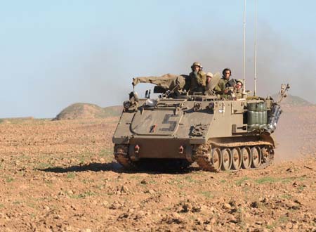An Israeli armored personnel vehicle march towards the south of the Gaza Strip, Jan. 6, 2009. Over 540 Palestinians have been killed and some 2,500 others injured in the Gaza Strip during Israel's Operation Cast Lead starting from Dec. 27, 2008. [Yin Bogu/Xinhua]