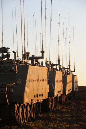 Israeli armored personnel vehicles are seen on the border of the northern Gaza Strip in the early morning Jan. 6, 2009. Over 540 Palestinians have been killed and some 2,500 others injured in the Gaza Strip during Israel's Operation Cast Lead starting from Dec. 27, 2008. [Yin Bogu/Xinhua]