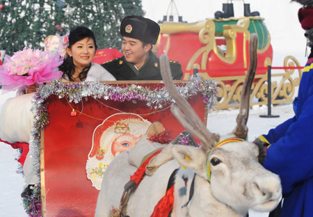 A couple poses for photos at a mass wedding ceremony held on Sun Island of in Harbin, capital of China's northeast Heilongjiang Province, on Jan. 6, 2009. The 25th Harbin Mass Wedding Ceremony was held on Tuesday with 22 couple joined in.[Wang Jianwei/Xinhua]