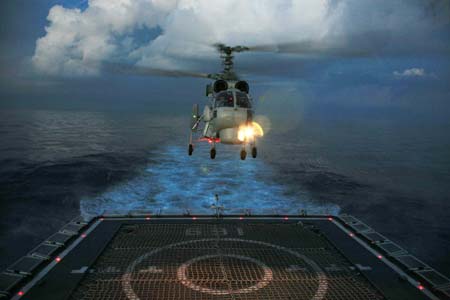 A helicopter of the Chinese naval fleet attends a landing exercise at night on Dec. 28, 2008, while the Chinese naval fleet heads for the Gulf of Aden. The Chinese naval fleet including two destroyers and a supply ship set off on Dec. 26 for waters off Somalia for an escort mission against piracy.[Xinhua]