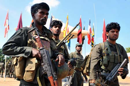 Some soldiers of Sri Lanka's government troops patrol on the street of the town of Kilinochchi, 328 km north of the capital Colombo, Jan. 4, 2009. Sri Lanka's government troops wrested from rebel Liberation Tigers of Tamil Eelam (LTTE) control the town of Kilinochchi, their former administrative headquarters, on Jan. 2.[Xinhua]