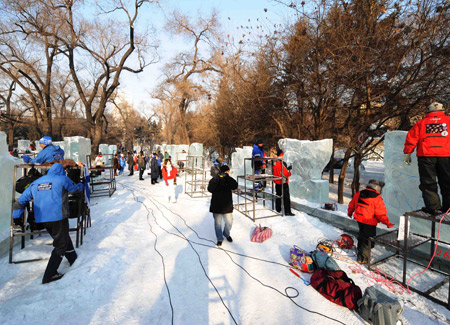 Competitors carve ice sculptures during the 23rd International Ice Sculpture Competition at the Zhaolin Park in Harbin, capital of northeast China's Heilongjiang Province, Jan. 6, 2009. [Xinhua]