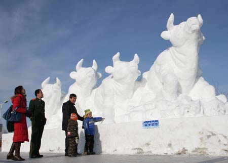 Tourists view snow sculpture 'Running Bulls Welcome the Spring' during the 4th Ice, Snow, Cultural and Tourism Festival in Barkol Kazak Autonomous County, northwest China's Xinjiang Uygur Augonomous Region, Jan. 5, 2009. 