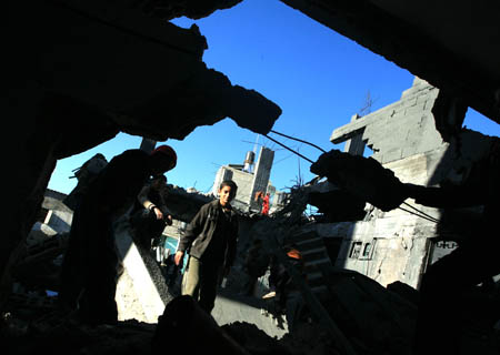 Palestinians inspect rubbles after an Israeli airstrike in Rafah, southern Gaza Strip, Jan. 6, 2009. Israeli Prime Minister Ehud Olmert on Tuesday rejected a European Union (EU) request for a 48-hour ceasefire in the Gaza Strip, vowing to push ahead the offensive in the Gaza Strip till security is restored to southern regions of Israel. [Wissam Nassar/Xinhua] 