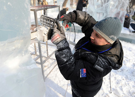 A competitor carves an ice sculpture during the 23rd International Ice Sculpture Competition at the Zhaolin Park in Harbin, capital of northeast China's Heilongjiang Province, Jan. 6, 2009. The three-day competition was opened at the park on Jan. 6, attracting more than 60 contestants from 12 countries and regions including China, Denmark, Finland, New Zealand and Russia. [Xinhua] 