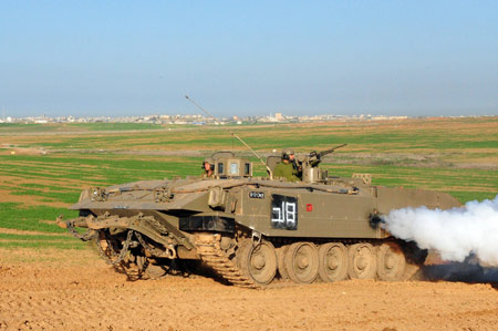 An Israeli tank runs in the northern Gaza Strip Jan. 7, 2009. The Israeli army has said that it would hold fire in the Gaza Strip for three hours every day from Jan. 7 to allow local residents to prepare basic supplies. [Ben-Ari/Xinhua]