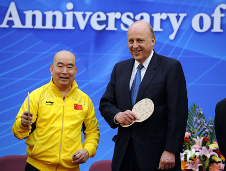 U.S. Deputy Secretary of State John D. Negroponte (R) poses with former Chinese ping-pong world champion Liang Geliang during the Friendship Ping-pong Match marking the 30th anniversary of the establishment of the China-U.S. diplomatic relations, at the State General Administration of Sport in Beijing, capital of China, Jan. 7, 2009. [Rao Aimin/Xinhua]