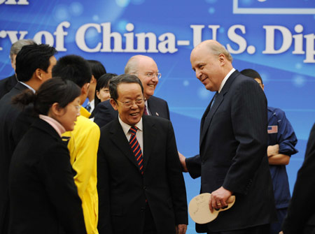 Chinese Vice Foreign Minister Wang Guangya (C) and U.S. Deputy Secretary of State John D. Negroponte (R Front) attend the Friendship Ping-pong Match marking the 30th anniversary of the establishment of the China-U.S. diplomatic relations, at the State General Administration of Sport in Beijing, capital of China, Jan. 7, 2009. [Rao Aimin/Xinhua] 