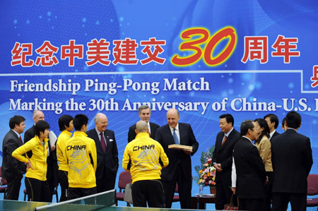 U.S. Deputy Secretary of State John D. Negroponte (C) meets with a Chinese ping-pong player during the Friendship Ping-pong Match marking the 30th anniversary of the establishment of the China-U.S. diplomatic relations at the State General Administration of Sport in Beijing, capital of China, Jan. 7, 2009.[Rao Aimin/Xinhua] 
