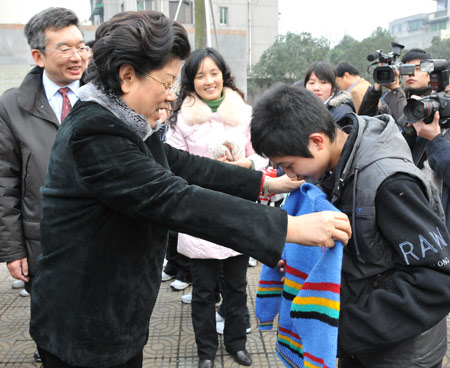 Chen Zhili (L), president of All-China Women's Federation and vice chairwoman of the Standing Committee of China's National People's Congress, selects a sweater for a student who lost parents during the devastating earthquake hitting Sichuan on May 12, 2008 at Tanghu High School in Dujiangyan City, southwest China's Sichuan Province, Jan. 6, 2009. 