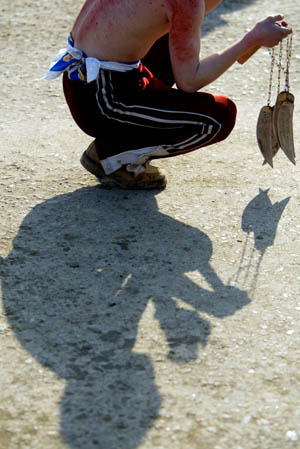 A Shiite Muslim rest after flagellating himself with chains during an Ashura procession in Kabul, capital of Afghanistan, Jan. 7, 2009. 