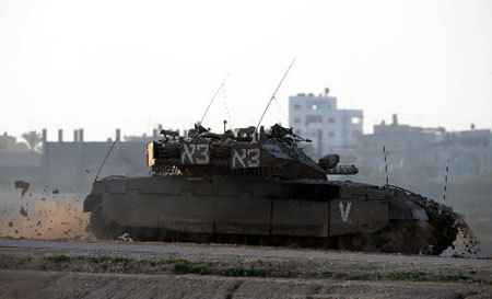 An Israeli tank passes across Gaza city on Jan. 8, 2009. (Xinhua Photo)