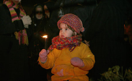 An Irani child holds a candle while praying for the children in Gaza during a rally at the Palestine Square in Tehran, capital of Iran, Jan. 7, 2009. Thousands of Irani people gathered at the square Wednesday night to support the Palestinian people.[Che Ling/Xinhua]