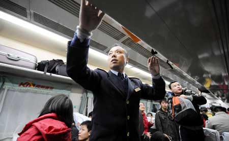 A steward works on a train at the Changsha Railway Station in Changsha, capital of central-south China's Hunan Province, Jan. 8, 2009. The Spring Festival travel period, known as Chunyun in Chinese, will start officially on Jan. 11. [Zhao Zhongzhi/Xinhua]