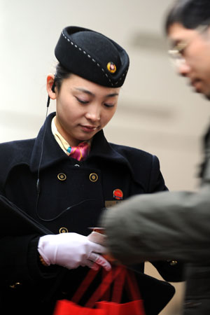 A stewardess works at the Changsha Railway Station in Changsha, capital of central-south China's Hunan Province, Jan. 8, 2009. The Spring Festival travel period, known as Chunyun in Chinese, will start officially on Jan. 11. [Zhao Zhongzhi/Xinhua]