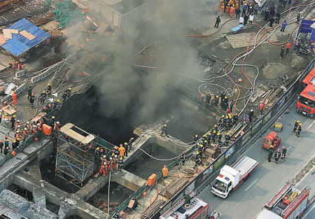 Smoke billows from the subway construction site in Shanghai yesterday, where one man was killed and six others were injured.