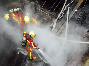 Shanghai firefighters brave heavy smoke to battle a blaze that trapped workers underground at a Line 11 Metro construction site and left one dead and six others severely injured. Hours earlier, a 50-ton crane toppled and crushed its operator to death at the site of a future Metro station on Line 9.