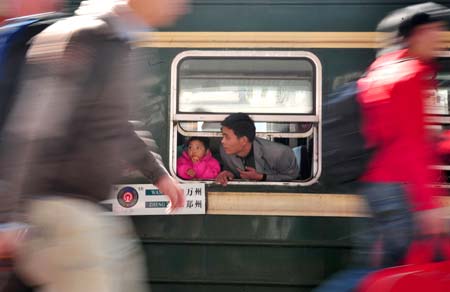 A man looks out from a window of train's carriage in Guangzhou Railway Station, in China's south Guangdong Province, Jan. 11, 2009. The 40-day travel peak before, during and after the Spring Festival holiday began on Sunday, with the estimation of 2.32 billion people to travel over the Chinese Lunar New Year holiday.[Xinhua] 