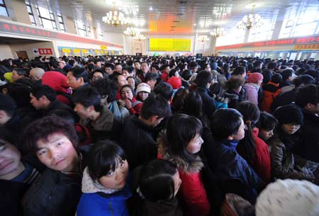 Passengers wait to buy tickets at the Beijing Railway Station in Beijing, capital of China, on Jan. 11, 2009. The 40-day Spring Festival transportation, or Chunyun in Chinese, began on Sunday, with the estimation of 2.32 billion people to travel over the Chinese lunar New Year starting from Jan. 26 this year. [Xinhua] 