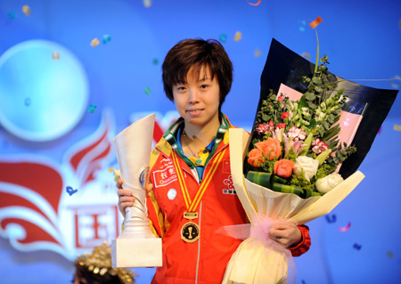 China's Zhang Yining holds the trophy during the awarding ceremony for the women's final of the 2008 table tennis tournament of champions in Changsha, capital of central-south China's Hunan Province, Jan. 11, 2009. Zhang claimed the title after beating her teammate Li Xiaoxia in the final by 4-1.
