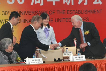 Former Chinese Vice Premier Qian Qichen (2nd L front) shakes hands with former U.S. President Jimmy Carter (1st R) after Qian's speech during The Seminar In Commemoration of The 30th Anniversary of The Establishment of Diplomatic Relations Between China And The United States, in Beijing, capital of China, Jan. 12, 2009. The seminar was opened on Monday. [Pang Xinglei/Xinhua]