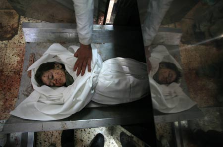 The body of Palestinian boy Fares Hamoda lies in the morgue of al-Shifa hospital in Gaza city on Jan. 11, 2009, after he was killed during Israel's military operation in the Gaza Strip. Israel's ongoing attacks on Hamas targets in the Gaza Strip have claimed almost 900 lives.[Xinhua]