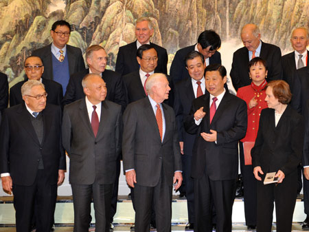 Chinese Vice President Xi Jinping (front, 2nd R) talks to former U.S. President Jimmy Carter (front, C), who is here to attend the commemorative events of the 30th anniversary of the establishment of diplomatic relations between China and the United States, while they are taking a group photo in Beijing, capital of China, Jan. 12, 2009. [Xinhua]