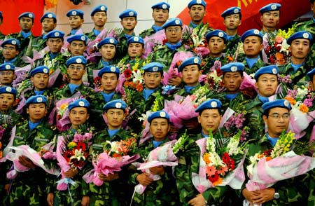 Members of the first batch of Chinese contingent of the UN-AU Mission in Darfur hybrid peacekeeping troops pose for a group photo during a welcoming ceremony for their arrival in Zhengzhou, capital of central China's Henan Province, Jan. 12, 2009. [Xinhua]