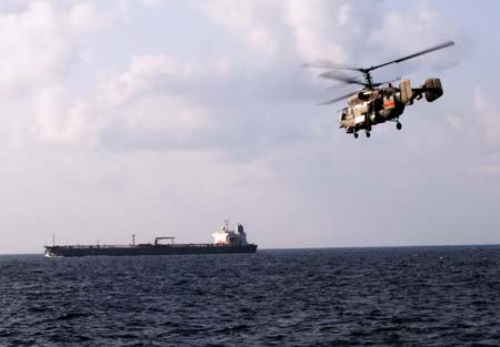  A Chinese navy helicopter keeps alert over a cargo ship in the waters of the Gulf of Aden on Jan. 12, 2009. The Chinese fleet started to carry out the second escort mission against pirates in the Gulf of Aden on Monday. [Xinhua]