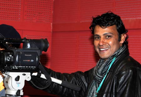 A reporter of India's New Delhi Television stands at the venue of the second meeting of the 9th Tibetan Regional Committee of the Chinese People's Political Consultative Conference in Lhasa, capital of southwest China's Tibet Autonomous Region, Jan. 12, 2009. 