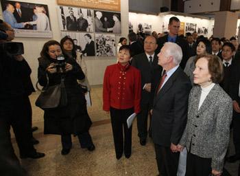 Former U.S. President Jimmy Carter (2nd R, front) and his wife Rosalynn Carte visit the photo exhibition marking the 30th anniversary of bilateral diplomatic ties between China and the United States in Beijing Jan. 12, 2009. The exhibition kicked off here on Monday. [Yao Dawei/Xinhua]