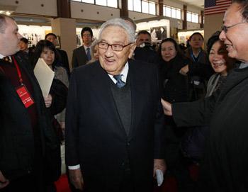 Former U.S. Secretary of State Henry Kissinger (C) attends the opening ceremony of the photo exhibition marking the 30th anniversary of bilateral diplomatic ties between China and the United States in Beijing Jan. 12, 2009. The exhibition kicked off here on Monday. [Yao Dawei/Xinhua]