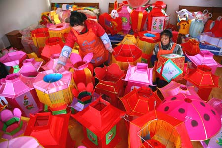 Workers make lanterns at a workshop at Hongmiao Village in Huairou District of Beijing, capital of China, Jan. 12, 2009. Some 2,200 lanterns have been made at the workshop for the Spring festival since the beginning of the last month of the lunar year. (Xinhua/Bu Xiangdong)