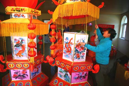 Workers make lanterns at a workshop at Hongmiao Village in Huairou District of Beijing, capital of China, Jan. 12, 2009. Some 2,200 lanterns have been made at the workshop for the Spring festival since the beginning of the last month of the lunar year. 