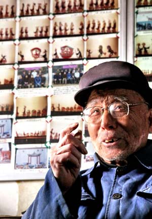 Farmer He Fulin, a shadow-play lover, talks about the shadow-play at home in Funing County, north China's Hebei Province, Jan. 11, 2009. Devoting himself to making, collecting and playing shadow-play, a Chinese traditional art, for more than 70 years, He has decided to pass it down to young people.[Liu Xuezhong/Xinhua]