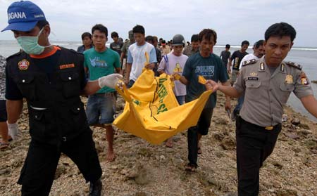 Local residents carry the body of a baby who died in the ferry sinking accident near Pare-Pare port, Sulawesi Island, Indonesia, on Jan. 13, 2009. 