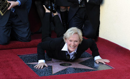 Actress Glenn Close smiles as she lays on top of her star on the Hollywood Walk of Fame in Los Angeles on Monday, Jan. 12, 2009. 