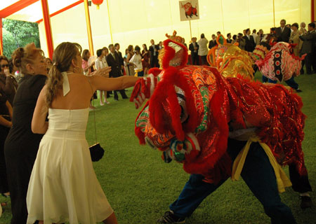 Overseas Chinese perform traditional lion dance during a Spring Festival reception at Chinese Embassy in Lima, Peru, on Jan. 13, 2009. 