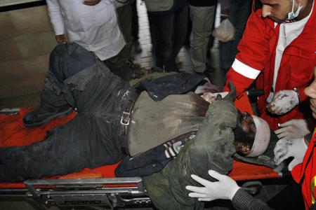 A Palestinian who was injured in an Israeli army strike is rushed to Shifa hospital in Gaza City, Tuesday, Jan. 13, 2009.[Xinhua]