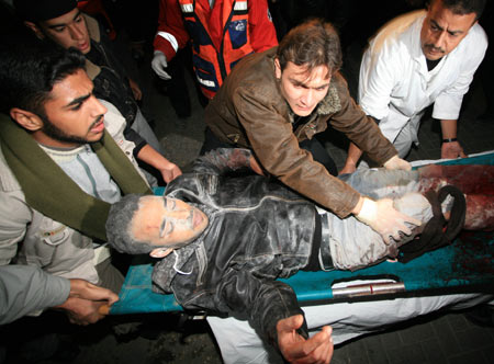 Palestinian medics send a wounded man of the Civil Defense, who was hurt in an Israeli strike, to Shifa hospital in Gaza City, Jan. 14, 2009. Gaza emergency chief Mo'aweya Hassanein said on Wednesday night that the Israeli army killed on Wednesday 28 Palestinians and wounded 80 others. [Wissam Nassar/Xinhua] 