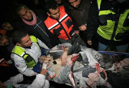 Palestinian medics send a wounded man of the Civil Defense, who was hurt in an Israeli strike, to Shifa hospital in Gaza City, Jan. 14, 2009. Gaza emergency chief Mo'aweya Hassanein said on Wednesday night that the Israeli army killed on Wednesday 28 Palestinians and wounded 80 others. [Wissam Nassar/Xinhua] 