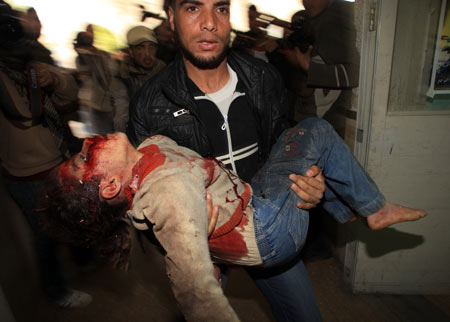 A wounded youth is carried to the hospital in Gaza City after an Israeli military operation on Jan. 15, 2009. [Wissam Nassar/Xinhua]