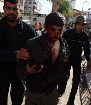 A wounded youth is escorted to the hospital in Gaza City after an Israeli military operation on Jan. 15, 2009. [Wissam Nassar/Xinhua] 