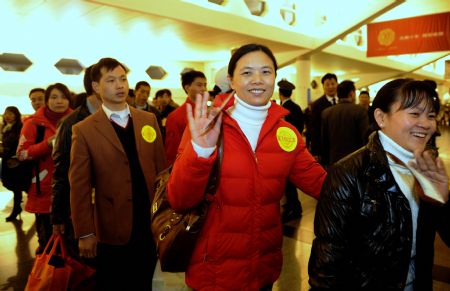 Rural immigrants from the earthquake-hit region in Sichuan Province wave goodbye at the Gaoqi Airport in Xiamen, southeast China's Fujian Province, on Jan. 15, 2009.[Xinhua]