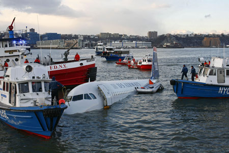 Emergency personnel search for passengers after a U.S. Airways plane landed in the Hudson River in New York, January 15, 2009. A US Airways jet with more than 150 people on board came down into the frigid Hudson River off Manhattan after apparently hitting a flock of geese on Thursday and officials said everyone was rescued. [Xinhua/Reuters] 