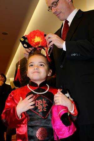 Jacqueline takes part in the Lunar New Year reception in Chinese costume with her father in New York, the United States, Jan. 14, 2009. Chinese Consulate General in New York and the delegation of China to the United Nations held a reception to celebrate the coming Chinese Lunar New Year.