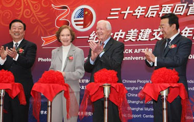 Former U.S. President Jimmy Carter (2nd R) applauds after cutting the ribbon for a picture exhibition marking the 30th anniversary of the establishment of China-U.S. diplomatic ties in Shanghai, east China, Jan. 16, 2009. Carter attended a symposium held by the Shanghai People's Association for Friendship with Foreign Countries and Shanghai Institute for International Studies commemorating the anniversary here on Friday.