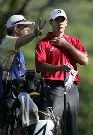 Charles Howell III of the U.S. talks with his caddie before teeing off on the sixth hole at the Sony Open golf tournament in Honolulu, Hawaii January 15, 2009.