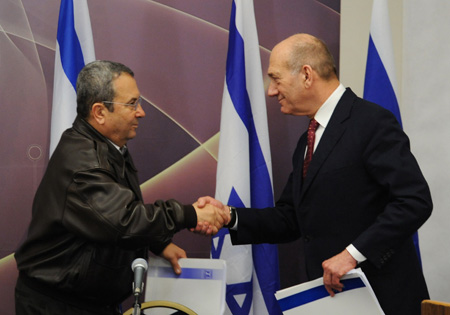 Israeli Prime Minister Ehud Olmert (R) shakes hands with Defense Minister Ehud Barak at a press conference after security cabinet meeting in Tel Aviv, on Jan. 17, 2008. 